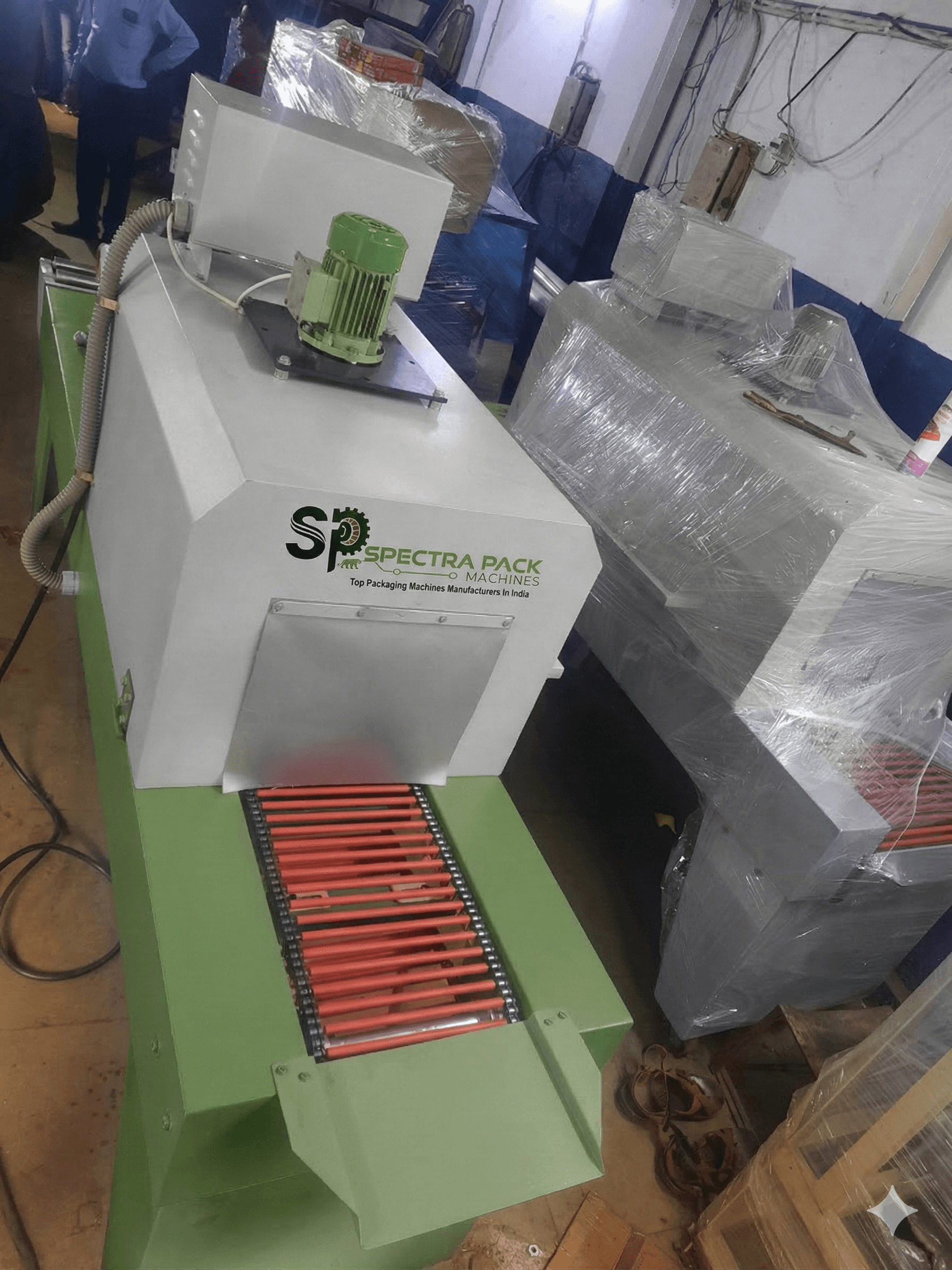 Fully automatic L-sealer with shrink tunnel machine by Spectra Pack Machines
